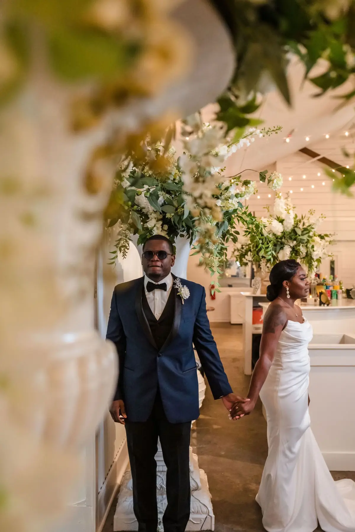 Bride down the aisle among the florals