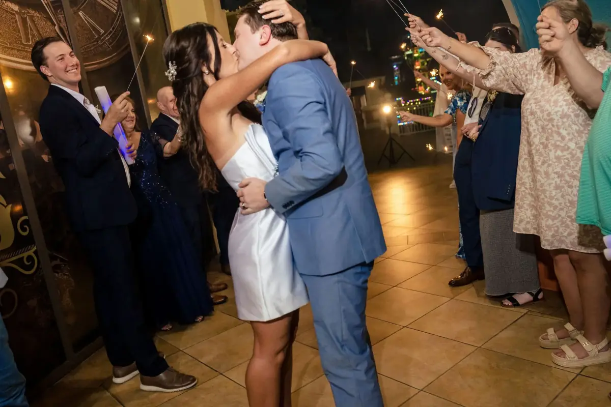 Couple kissing as guests cheer