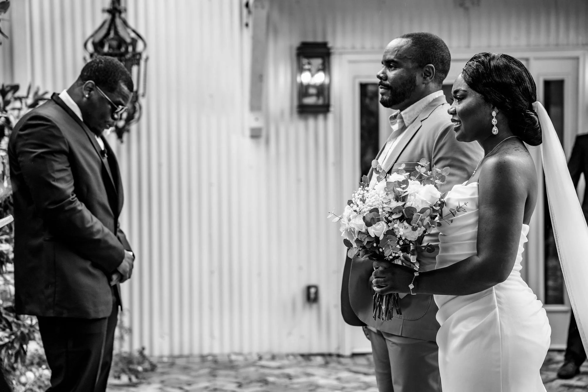 Black-and-white kiss with the bouquet in shadow