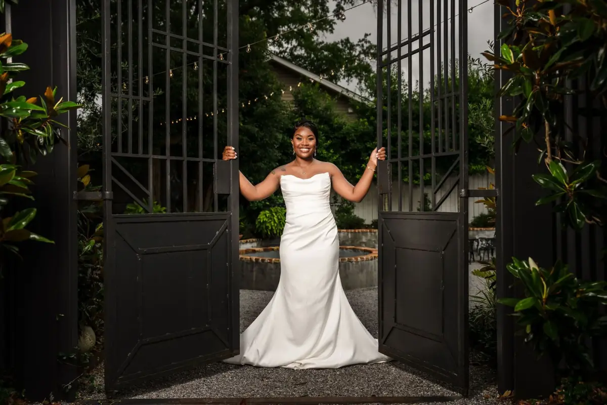 Bride looking back at the iron gates
