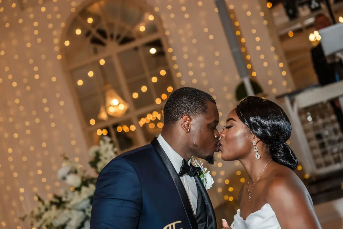 Kiss aglow against the fairy lights