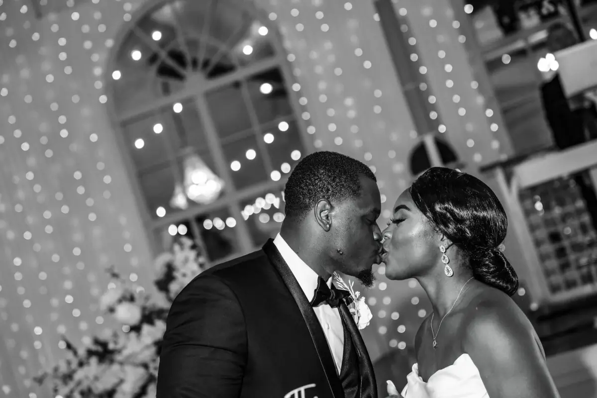 Black-and-white moment by the string lights