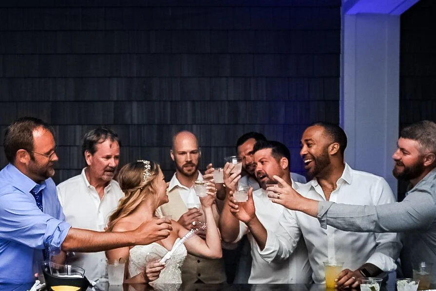 Groomsmen hoisting the groom in celebration