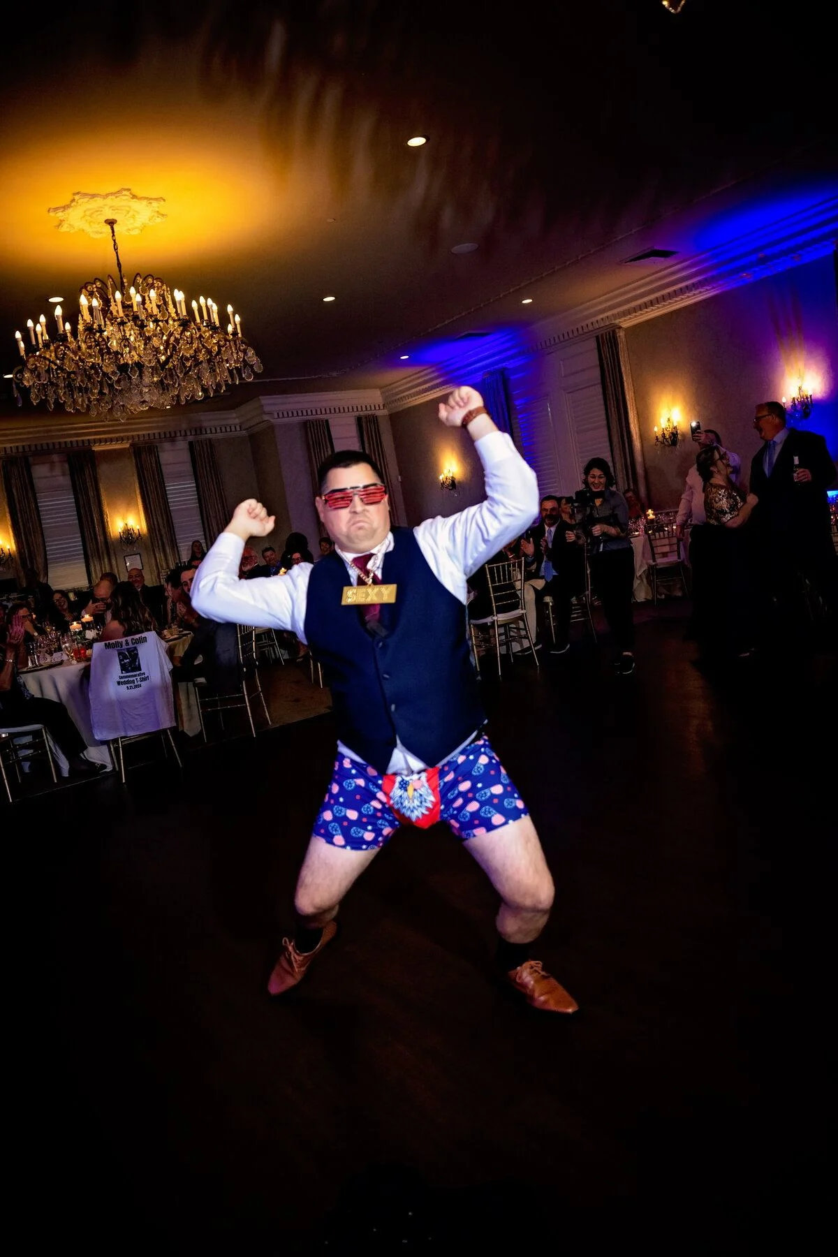Groom dancing under blue light