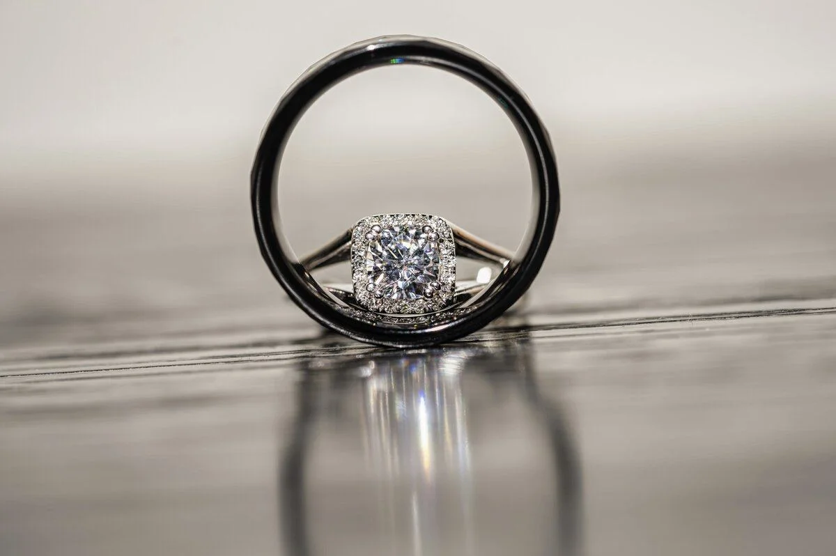 Macro of a diamond ring on dark glass
