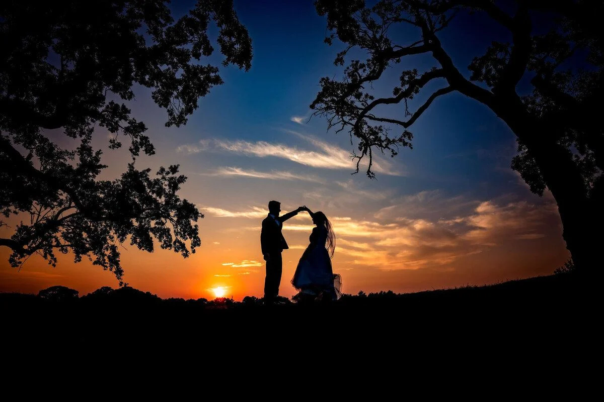 Couple beneath a great tree at sunset