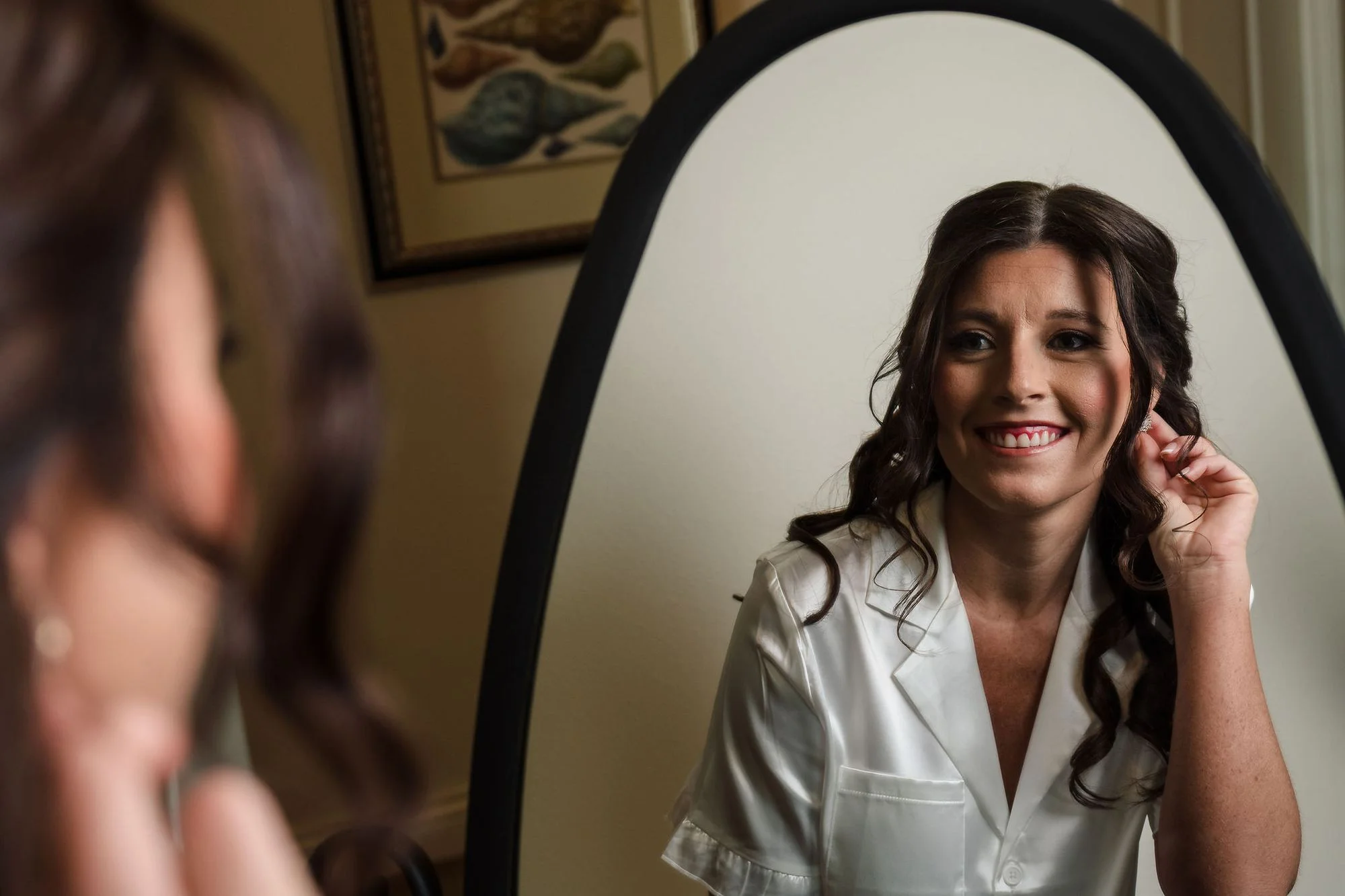 Black-and-white bride in her robe at the mirror