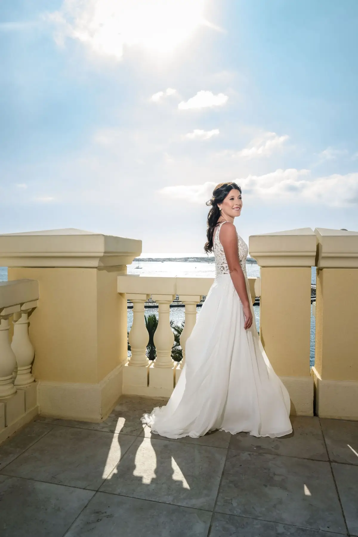 Bride on the rooftop terrace under blue sky