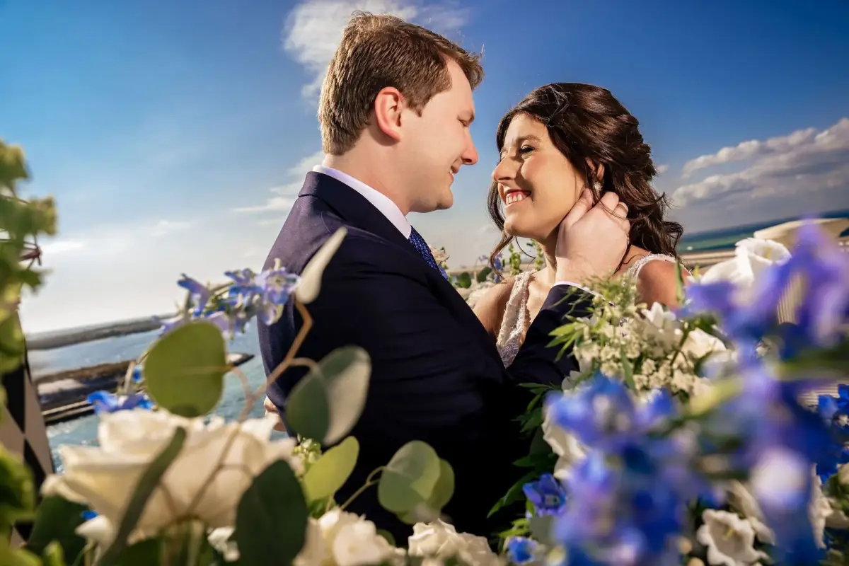 Couple kissing among the blue blossoms