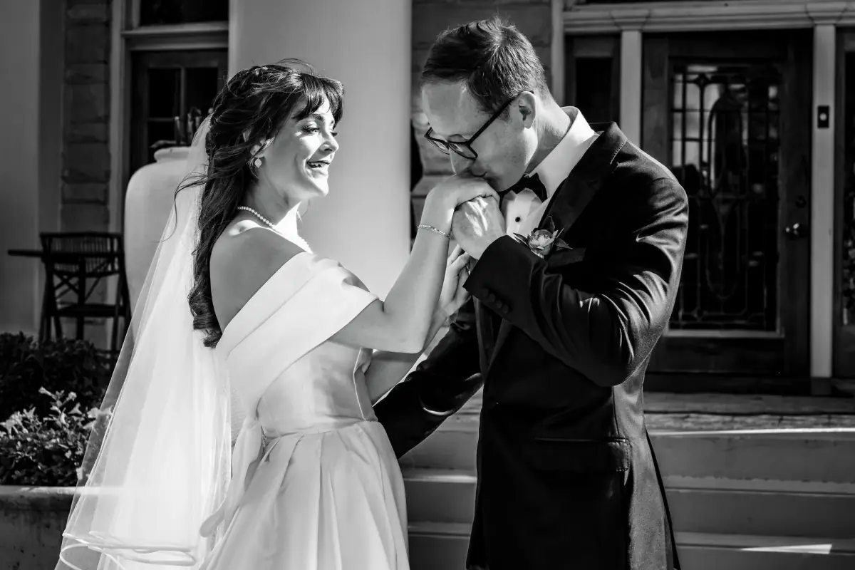 Bride and groom hold each other close in soft monochrome