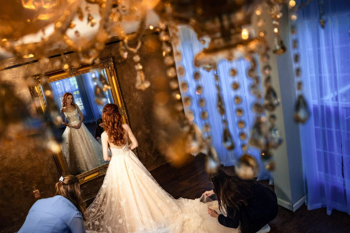 Couple beneath a canopy of warm string lights at the reception