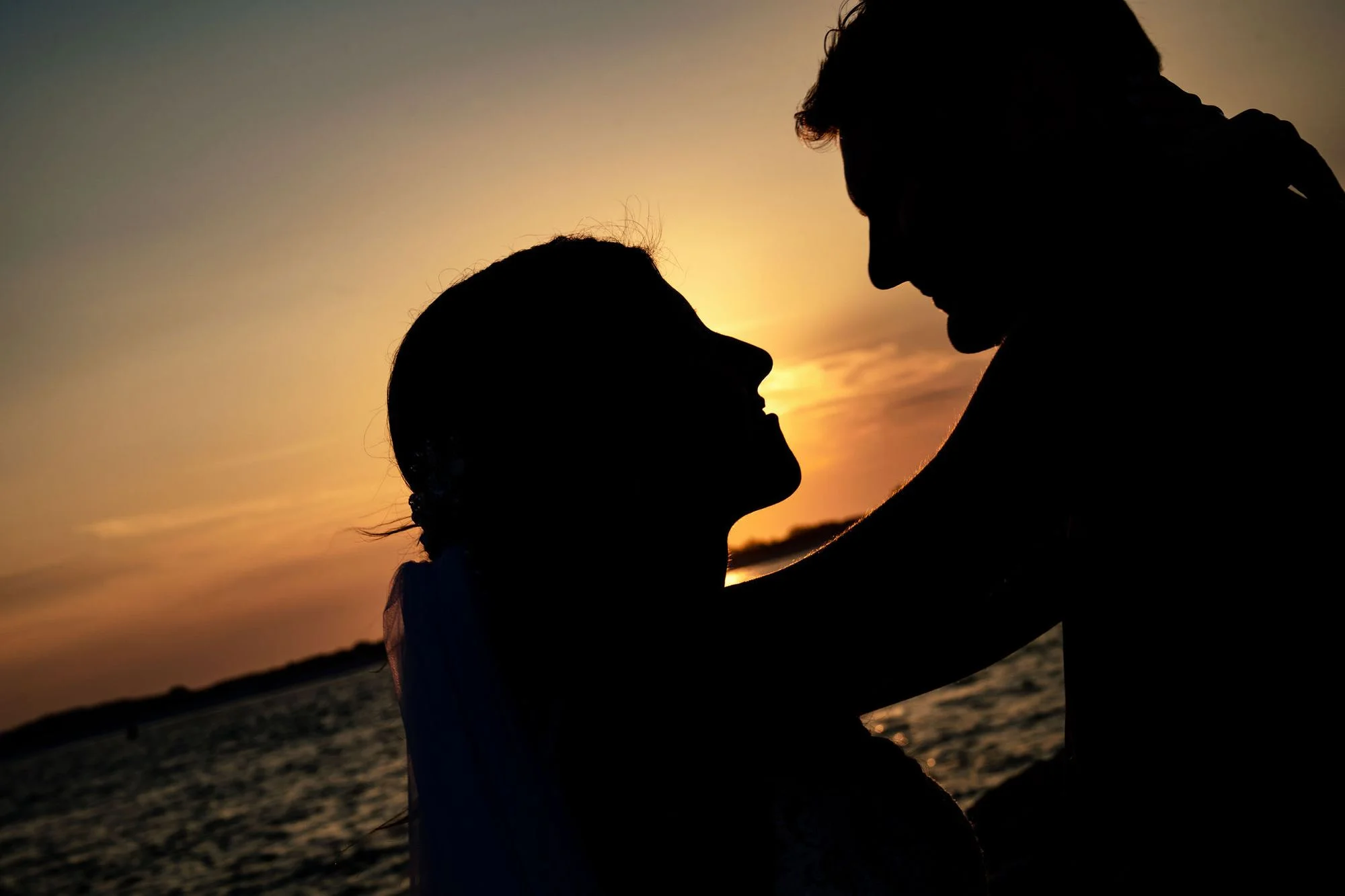 Silhouetted couple against a blaze of evening light