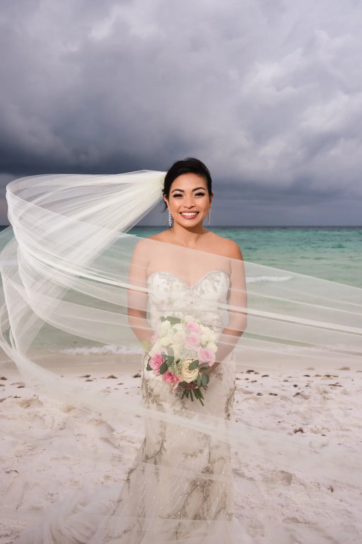 Veil lifting in the breeze along a moody shoreline