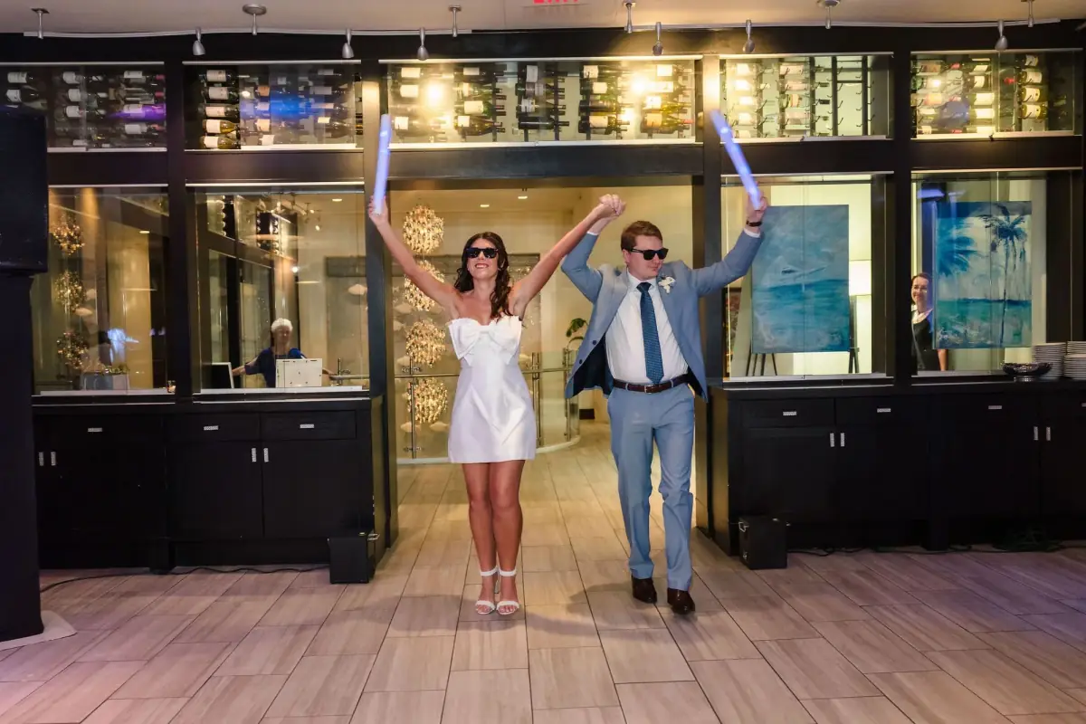 Newlyweds framed in a glowing arched doorway