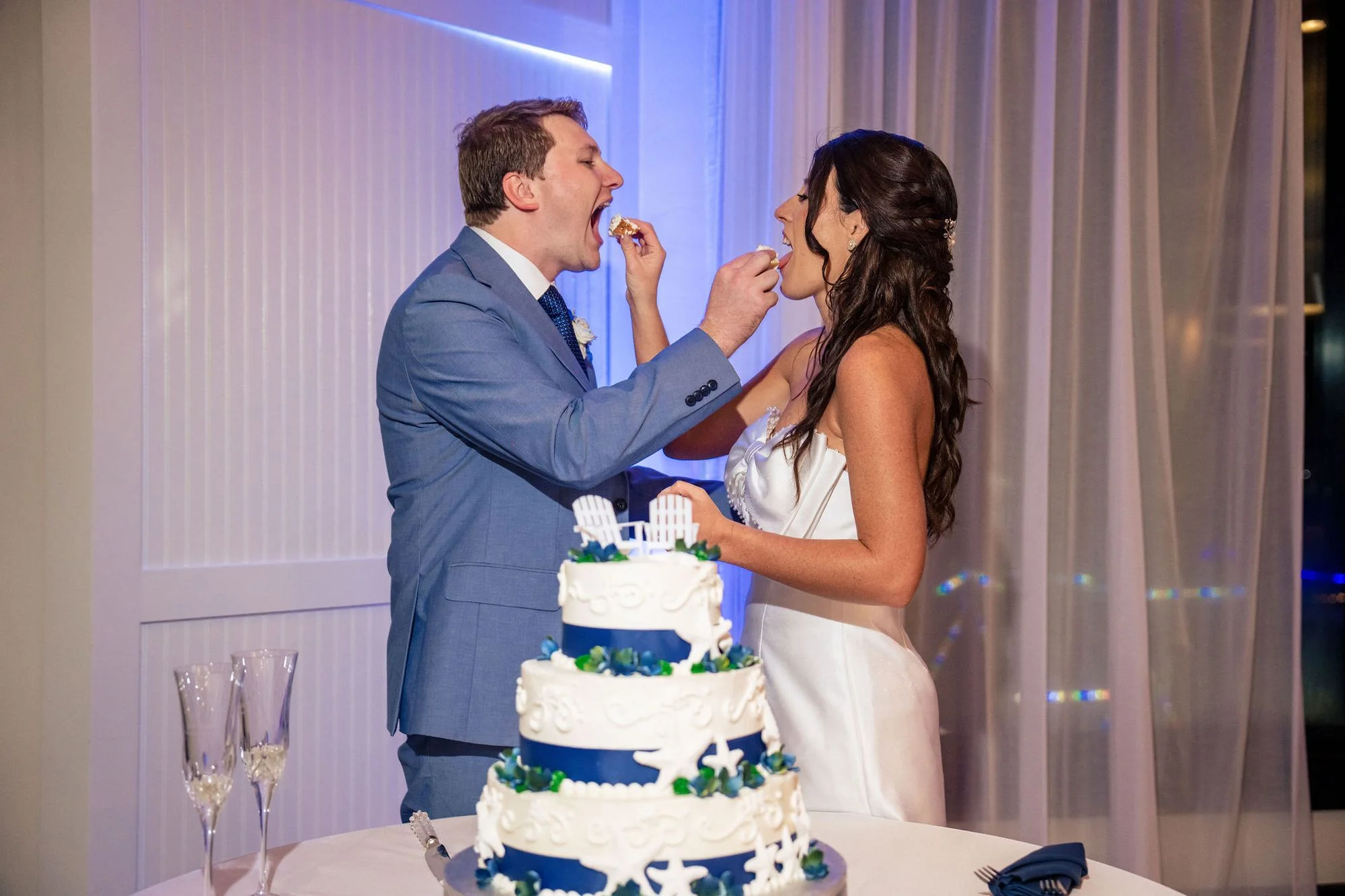 Cutting the tiered cake together at the reception