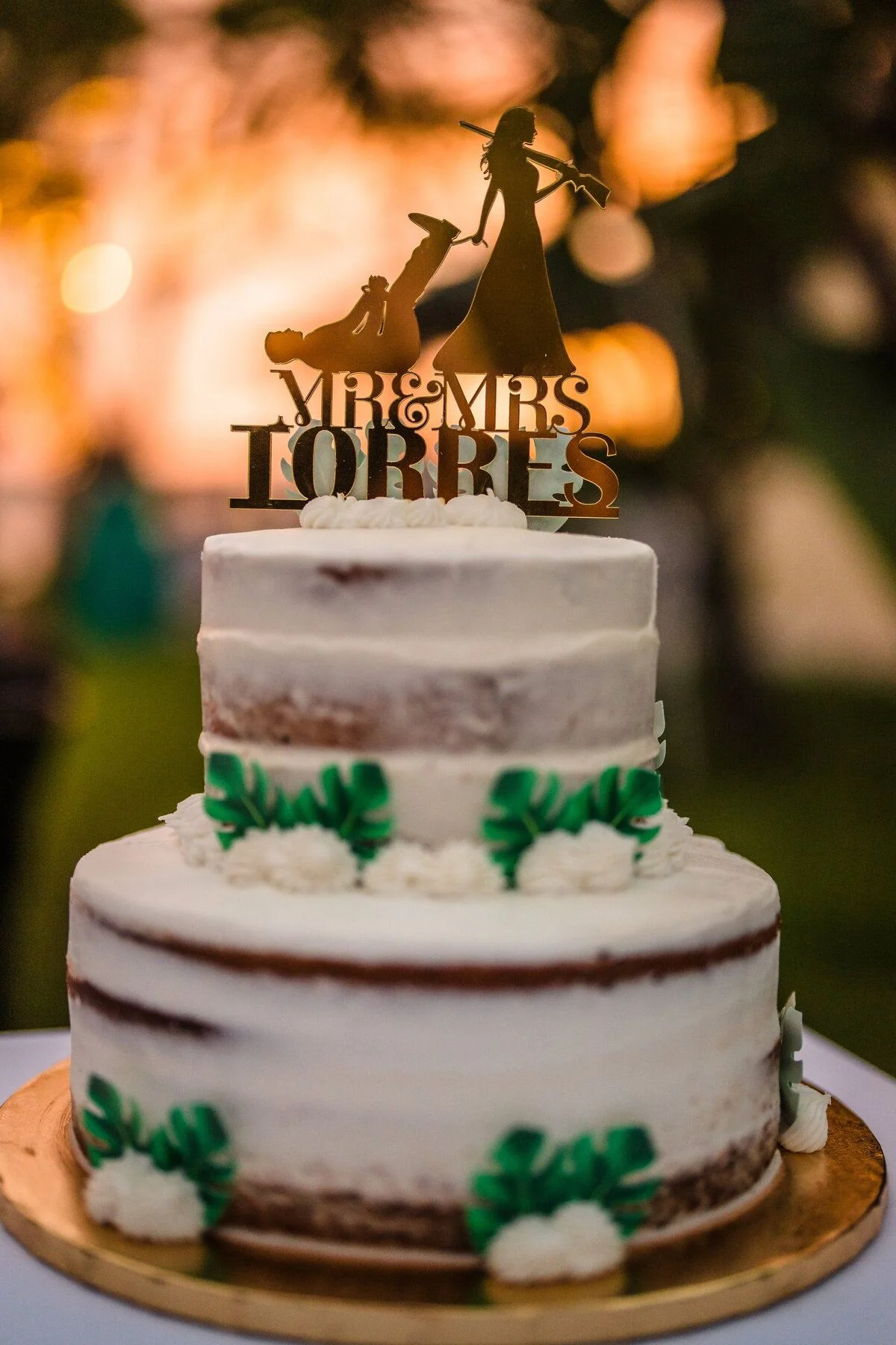 Tiered cake crowned with a glowing gold topper